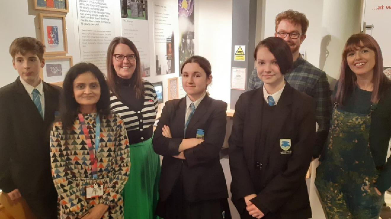 Students with their work on display and representatives from the LongBrow Creative team