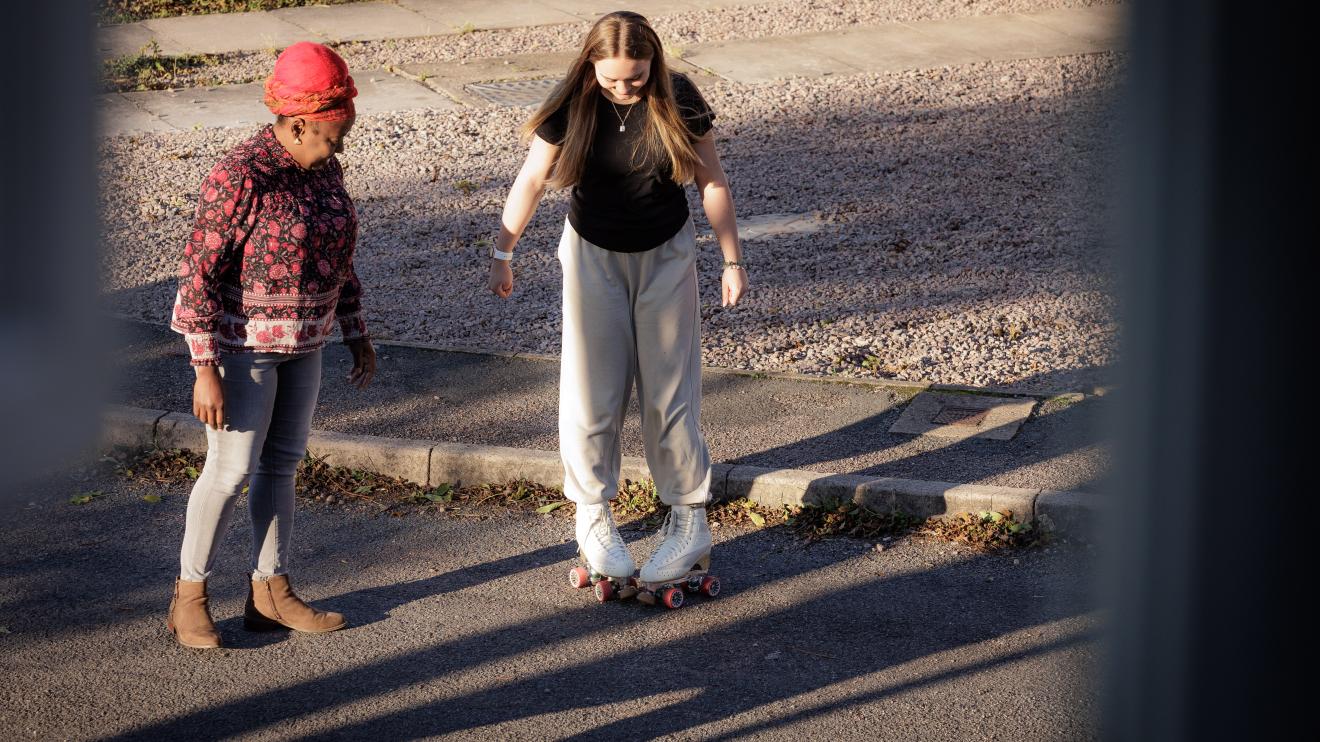 Female Independent visitor with girl on roller-skates  