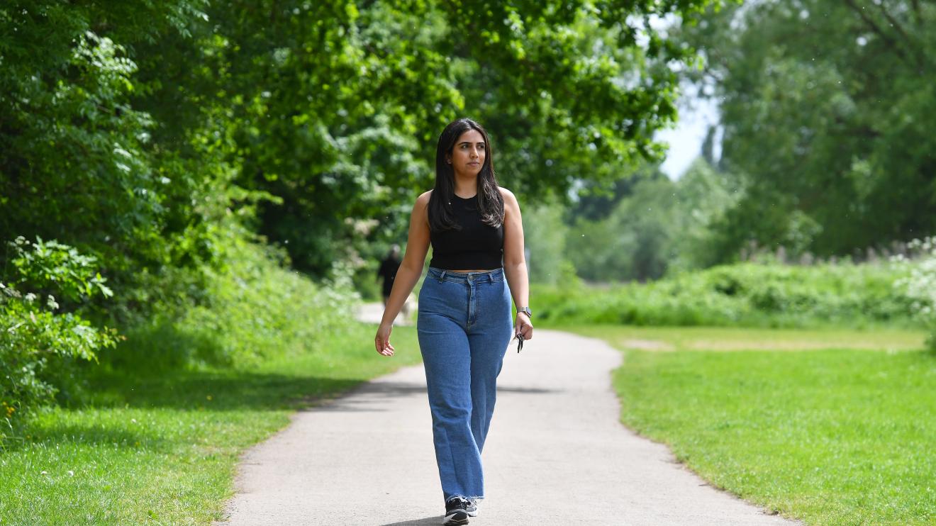 a woman walking at watermead country park