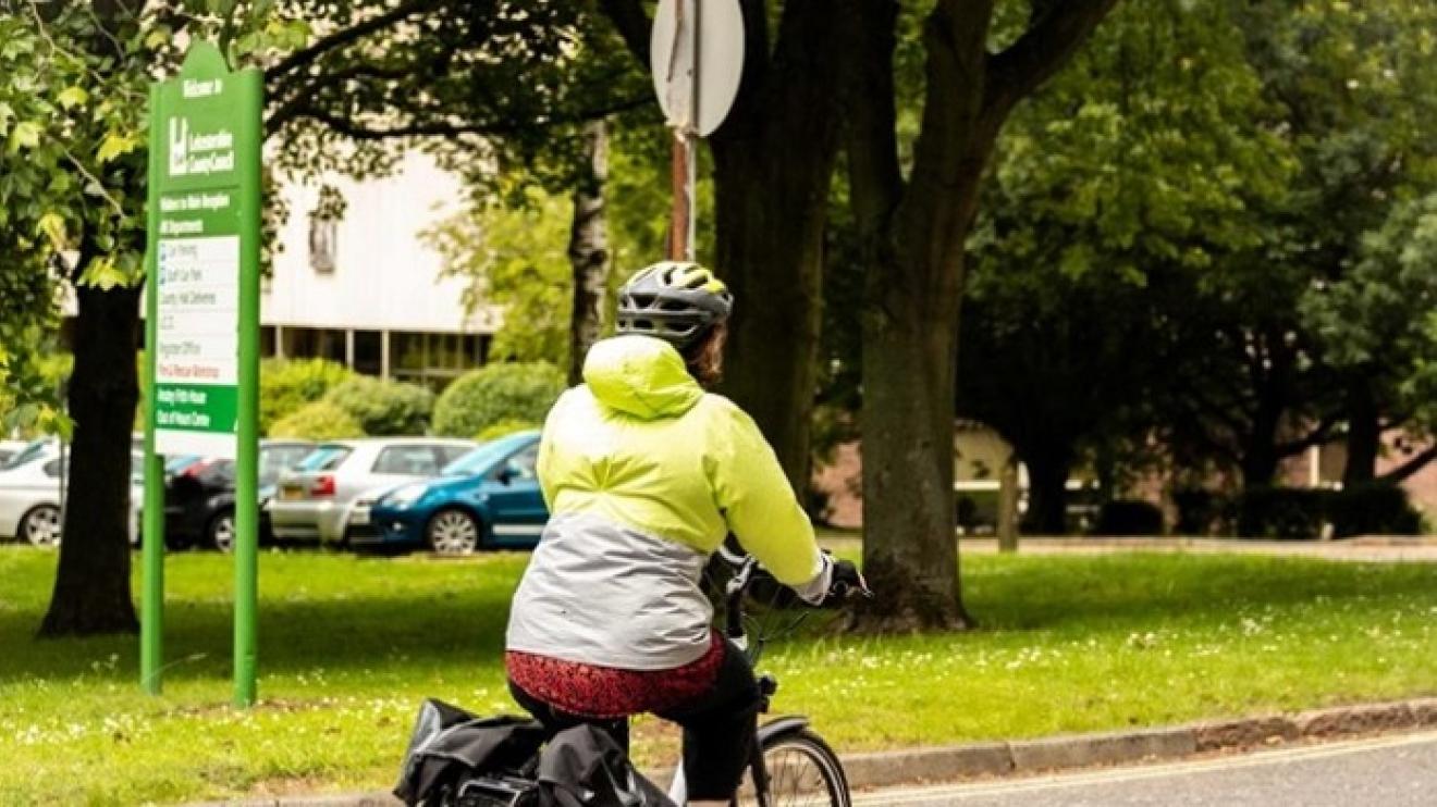 Leicestershire county council employee riding  bike into work, wearing a hi-vis jacket