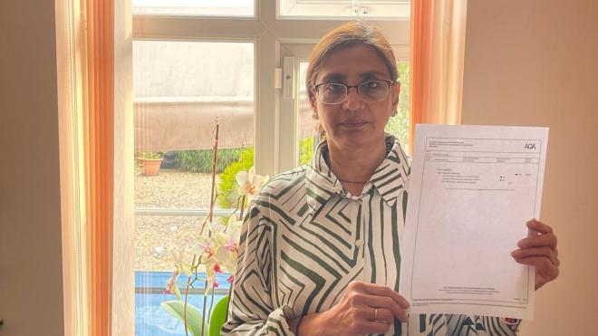 Primary school teacher Roopa Shukla holds her GCSE certificate