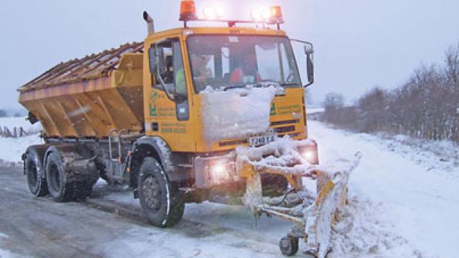 Gritter in snow with snow plough