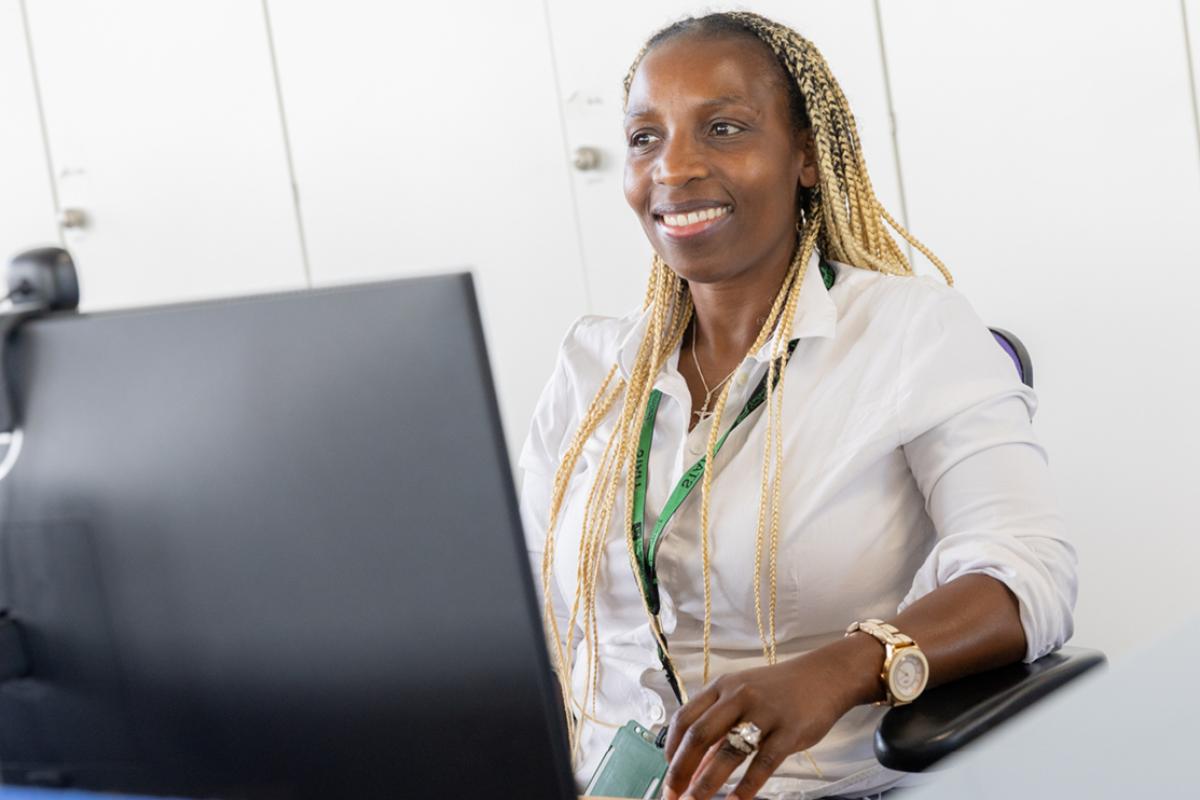 Leicestershire County Council staff facing a monitor and smiling