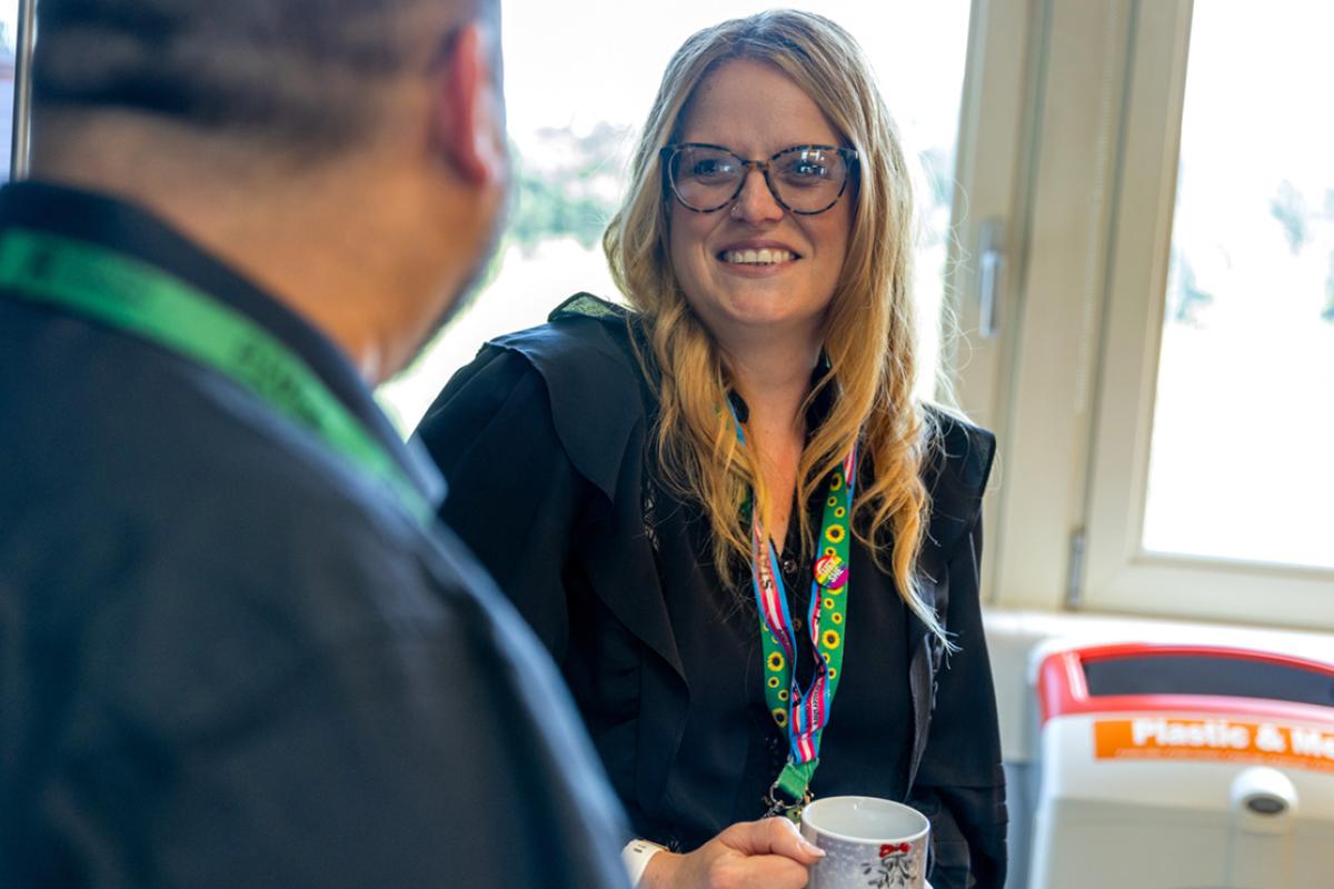 Two Leicestershire County Council staff facing each other and smiling